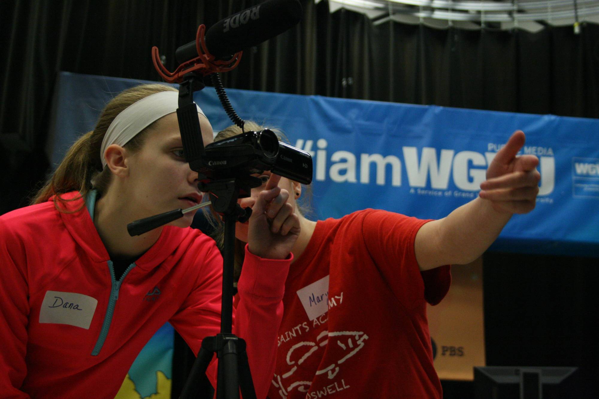People looking through a video camera on set